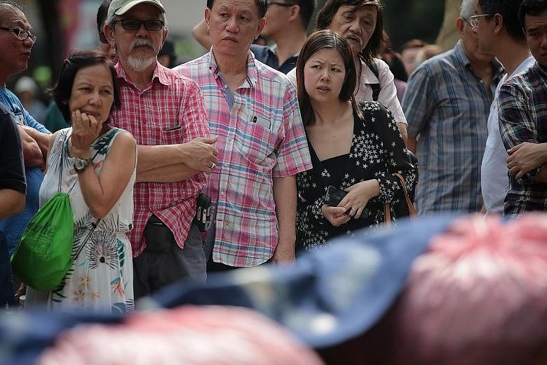 Hyflux investors gathering at the Speakers' Corner of Hong Lim Park yesterday. The water treatment firm owes a total of $900 million to some 34,000 perpetual securities and preference shareholders. But investors stand to suffer heavy losses from the 