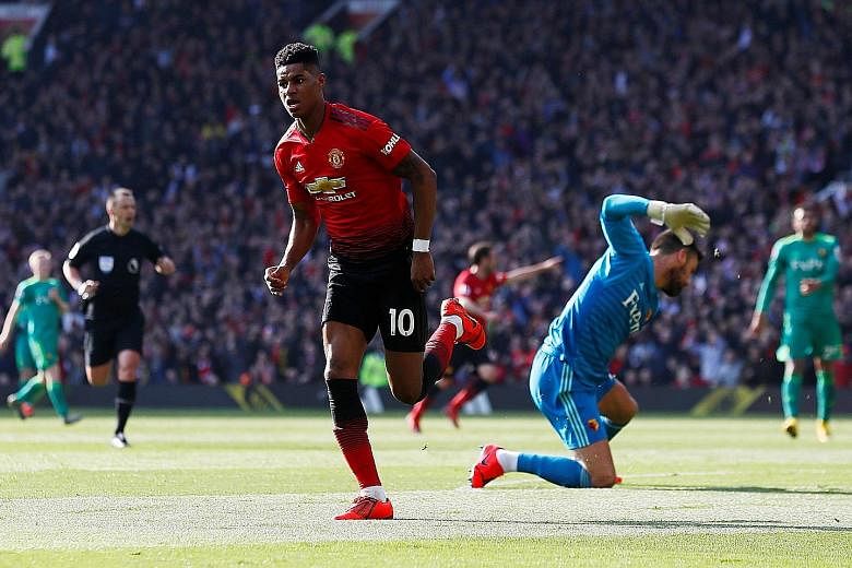 Manchester United forward Marcus Rashford celebrating scoring the opening goal, while Watford goalkeeper Ben Foster vents his frustration in United's 2-1 Premier League win yesterday - Ole Gunnar Solskjaer's first since being appointed as permanent m