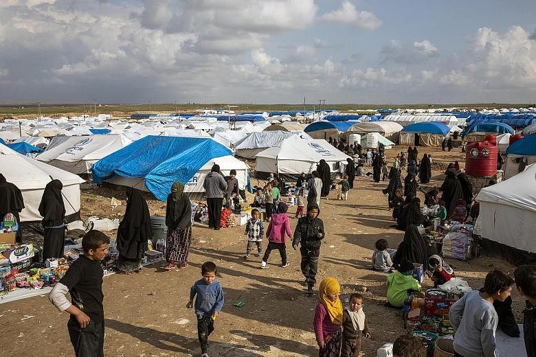 Women and children who fled ISIS' last areas of control in Syria at the Al Hol camp last Thursday. Approximately 67,000 internally displaced people were living in the camp, which has a capacity of 10,000, as of March 14.
