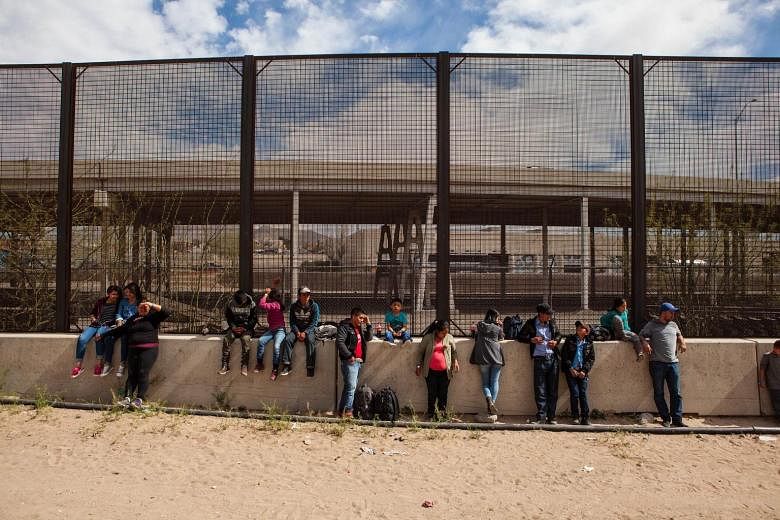 A group of migrants from Honduras, Guatemala and Salvador awaiting processing underneath the Paso Del Norte Bridge in El Paso, Texas. US Customs and Border Protection has temporarily closed all highway checkpoints along the 430km stretch of border in