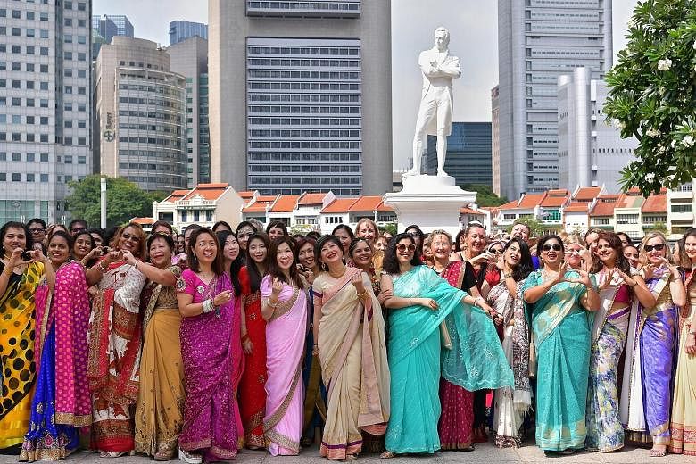 A sea of colours swept through the banks of the Singapore River yesterday as more than 200 women of 42 nationalities decked in saris gathered in front of the statue of Sir Stamford Raffles. Singaporeans, permanent residents and non-Singaporeans from 