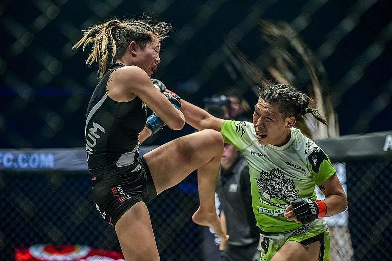 Angela Lee (in black) lost her challenge for the strawweight title of China's Xiong Jingnan in Tokyo yesterday. Now, instead, Xiong plans to drop a weight class to contest for Lee's atomweight title.