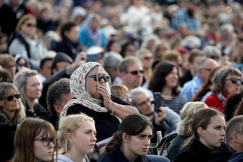 Attendees at a remembrance service at Christchurch's North Hagley Park last Friday for the victims of the March 15 shootings. A week after the attacks, New Zealand proposed new laws to ban military-style semi-automatic weapons. PHOTO: AGENCE FRANCE-P