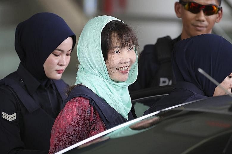 Vietnamese national Doan Thi Huong's father Doan Van Thanh outside the High Court in Shah Alam yesterday. Vietnamese national Doan Thi Huong is all smiles as she is escorted from the Shah Alam High Court after Malaysian prosecutors dropped the murder