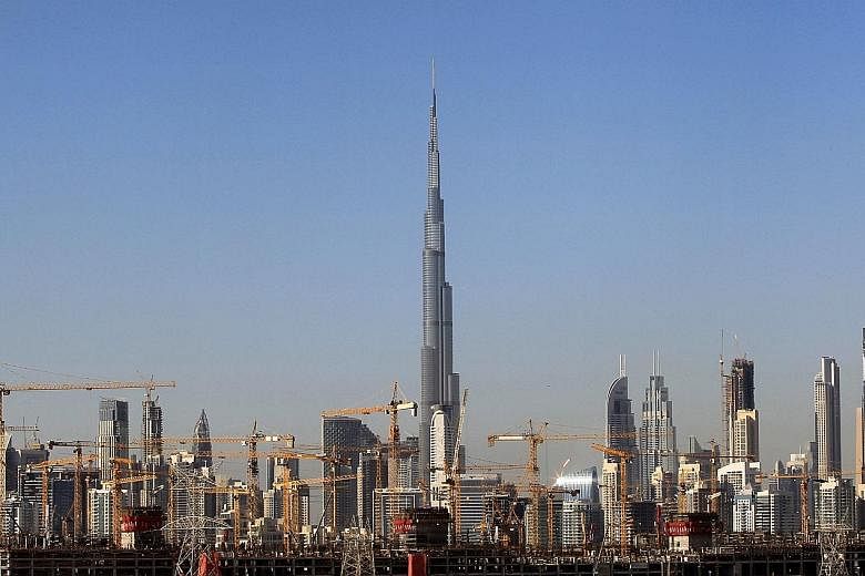 The Dubai skyline, in the United Arab Emirates, remains dotted with dozens of cranes, but amid a second downturn in a decade many stand idle. Property prices are down by at least 25 per cent since 2014 and growth in gross domestic product decelerated