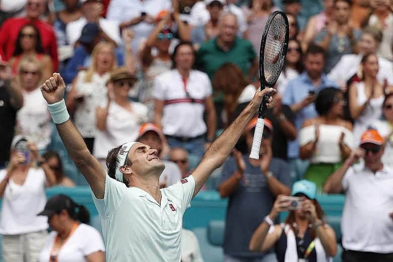 Roger Federer of Switzerland celebrating his 6-1, 6-4 victory over American John Isner in the Miami Open final on Sunday. It was his 101st career title and fourth in the tournament.