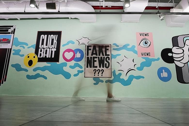 Graphics on the fake news issue in the underground pavement leading to the Esplanade last year. Law and Home Affairs Minister K. Shanmugam said leaving falsehoods to spread will crowd out legitimate debate.
