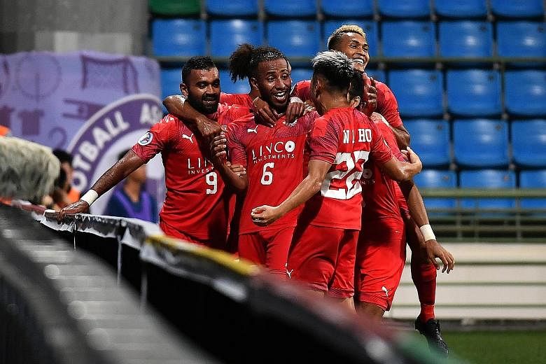 Home United players celebrate Abdil Qaiyyim's (No. 6) goal against Lao Toyota in their AFC Cup group tie. The defender's strike gave Home a 1-0 win, their first in the competition.