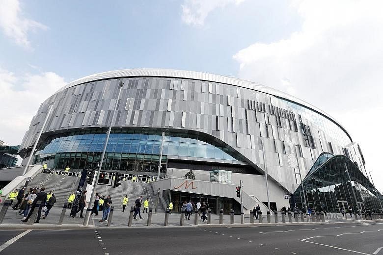 Top: Fans stream into the new Tottenham Hotspur stadium to watch Spurs legends play their Inter Milan counterparts. Above: The stadium had earlier hosted Tottenham's U-18 Premier League match against Southampton, during which Spurs' J'Neil Bennett ha