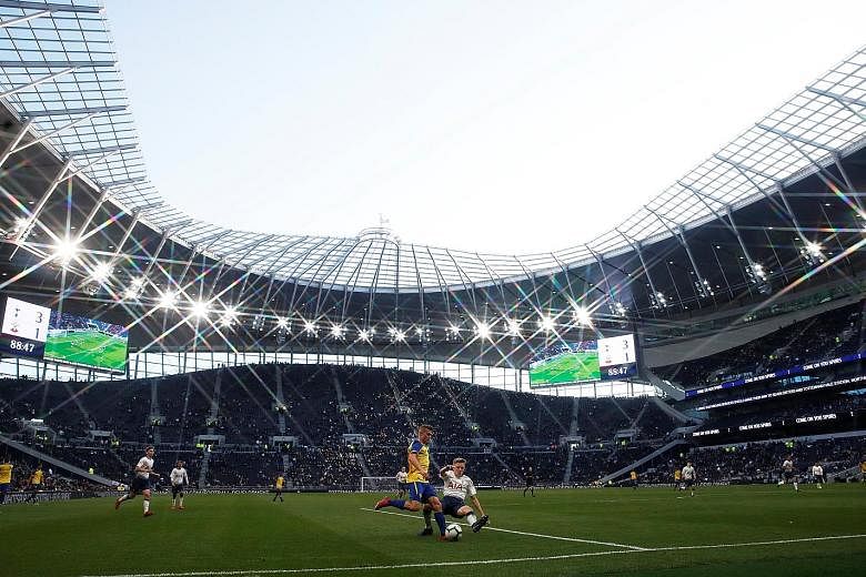 Top: Fans stream into the new Tottenham Hotspur stadium to watch Spurs legends play their Inter Milan counterparts. Above: The stadium had earlier hosted Tottenham's U-18 Premier League match against Southampton, during which Spurs' J'Neil Bennett ha