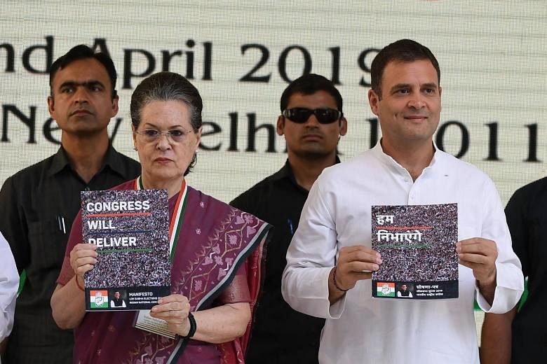 India's Congress party president Rahul Gandhi and his mother, former party president Sonia Gandhi, presenting the election manifesto in New Delhi yesterday.