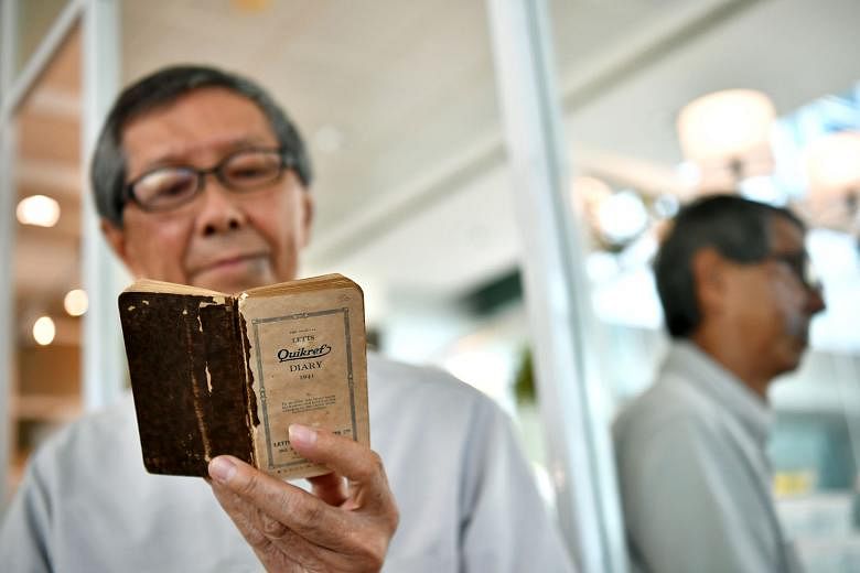 Mr Loh Kok Onn, 76, with his father's diary. It captured the colourful life that his father Loh Boon Thim had led in the last days of peace before the Japanese dropped bombs on Singapore in late 1941.