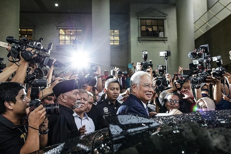 Former Malaysian premier Najib Razak (centre) leaving the Kuala Lumpur High Court yesterday. In this trial, Najib faces three counts of criminal breach of trust, one charge of abuse of power and three counts of money laundering involving funds from S