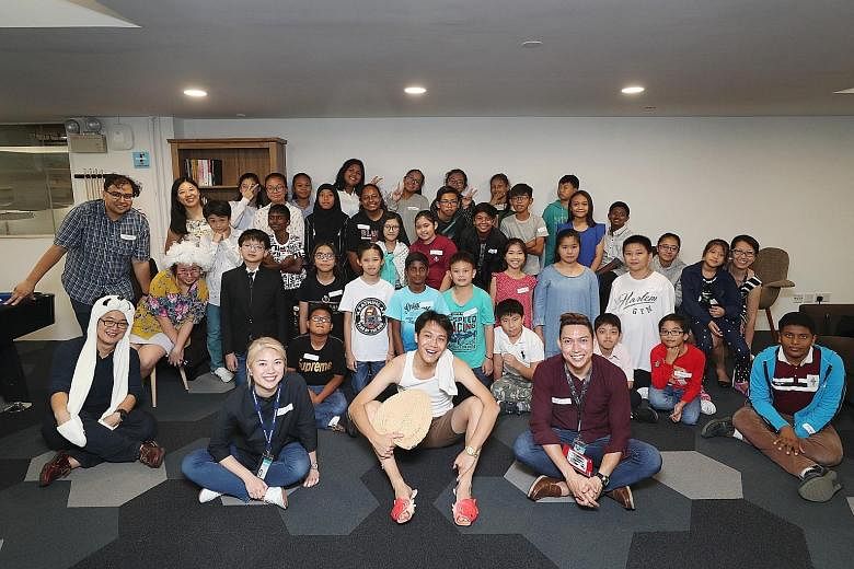 Beneficiaries of The Straits Times School Pocket Money Fund with Straits Times journalists during an outing at the ST newsroom on March 19.