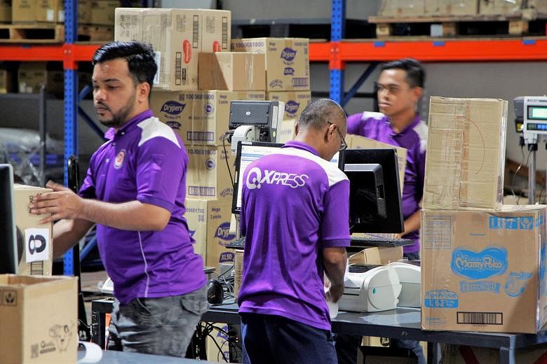 Qoo10's sorting and delivery facility in Toh Guan. The e-commerce company's share of Singapore's online shopping market more than quadrupled to 38.2 per cent from 2013 to last year, according to Euromonitor. It has held on to its leading position wit