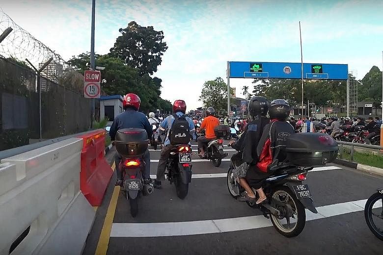 Motorcyclists heading to Singapore across the Causeway yesterday morning. While Malaysian media reported that congestion at the Causeway and Tuas Checkpoint on Monday was worse than usual, an app tracking the jams said the only difference was that Mo