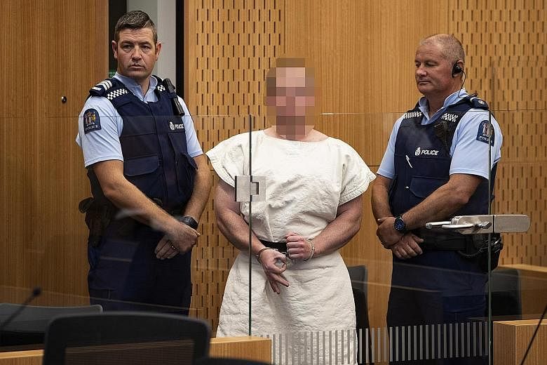 Brenton Tarrant making a sign to the camera during his appearance, on a charge of murder for the Christchurch mosque massacres, in a District Court last month. The media is allowed to publish only pixellated images of Tarrant.