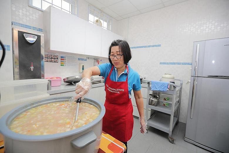 Madam Sim, 58, an in-house cook, preparing lunch at a PCF Sparkletots pre-school in Sengkang yesterday. Since Monday, 15 of the 16 Sparkletots pre-schools using Kate's Catering, which is linked to the latest spate of gastroenteritis, have switched ba