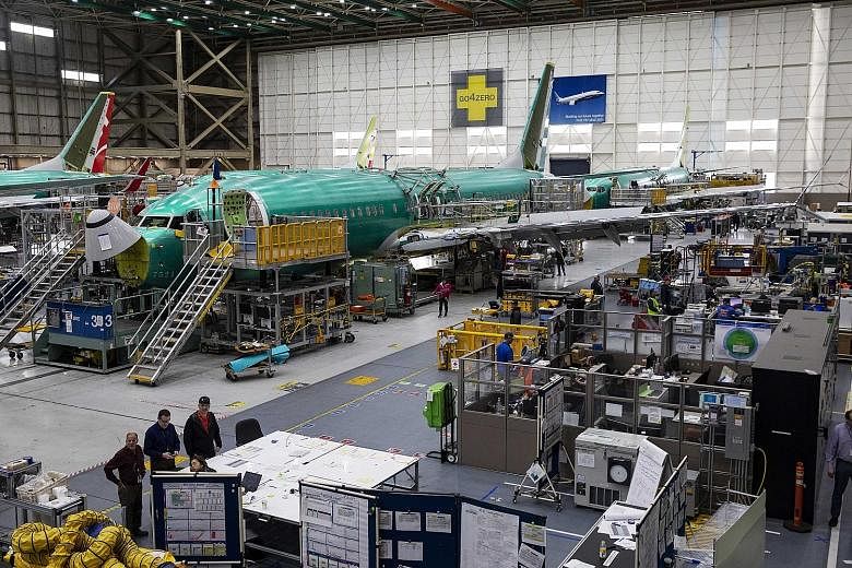 B-737 Max planes on the assembly line at the Boeing plant in Washington state late last month. Boeing is cutting production of its 737 jetliner for the first time since the Sept 11, 2001, attacks as the planemaker works to limit financial damage from