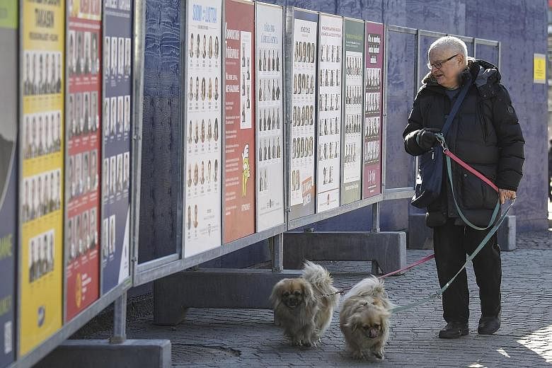 A man looking at campaign posters in Helsinki, with the parliamentary elections scheduled to be held in Finland on April 14. The country and its rapidly ageing population is a vivid demonstration that demographic change forces hard choices between po