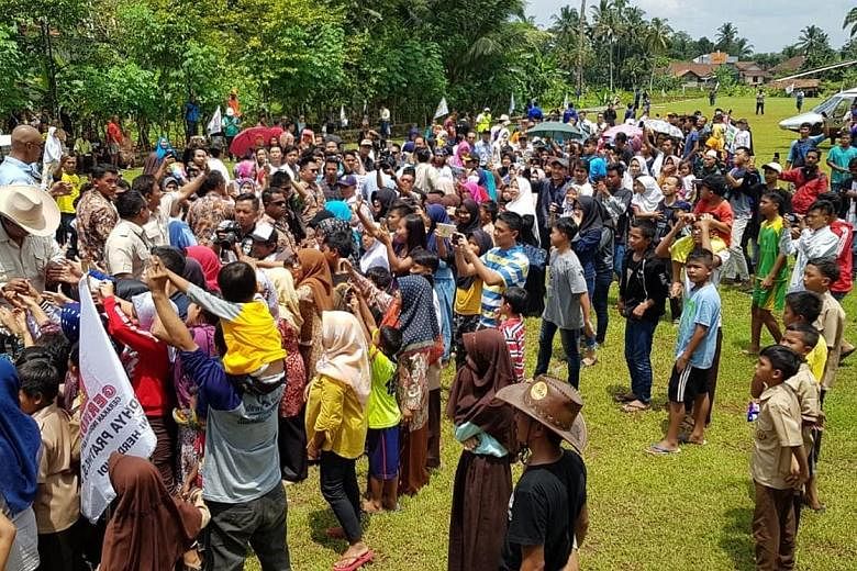 Mr Prabowo speaking in Ciamis yesterday, where he promised, if elected, to cut electricity costs within his first 100 days in office. A crowd bidding farewell to Mr Prabowo Subianto in Ciamis regency after his campaign stop there yesterday. The modes