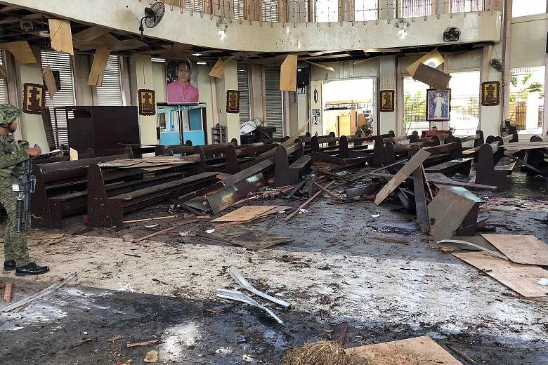 A Philippine soldier inspecting the damage inside a church after a bombing attack in Jolo on Jan 27 this year, in this handout photograph from the Armed Forces of the Philippines - Western Mindanao Command.