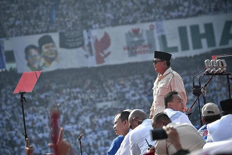 Presidential hopeful Prabowo Subianto speaking to supporters at Jakarta's Gelora Bung Karno stadium yesterday. He said that he is disgusted at how corruption has denied Indonesians the opportunity to prosper.