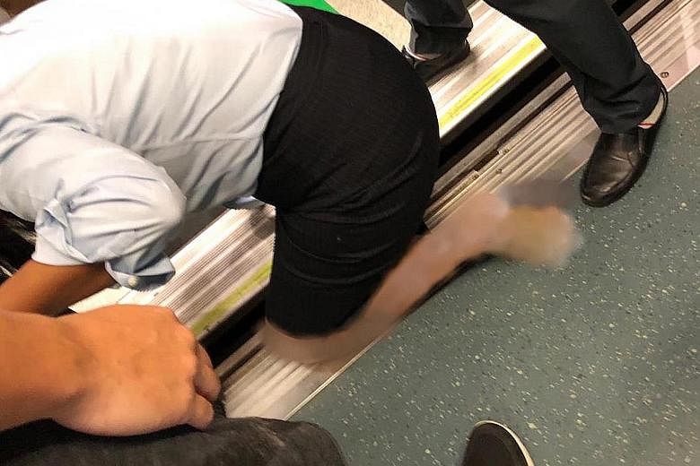 Above: The woman was taken to the National University Hospital after the incident. Left: Commuter Brandon Wong said he tried to calm the woman down and assisted SMRT staff in lifting her leg out of the gap.