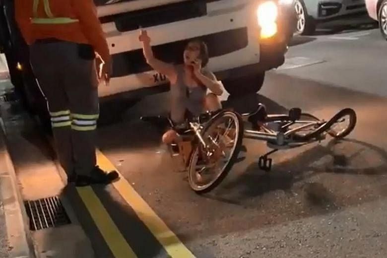 The cyclist is seen in a video clip shouting at the driver of the truck. Her mangled bicycle lies nearby.
