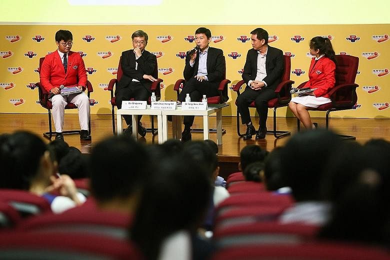 Associate Professor Gu Qingyang (second from left), Senior Minister of State for Trade and Industry Chee Hong Tat (centre) and Dr Tang Siew Mun speaking at a forum at River Valley High School yesterday.
