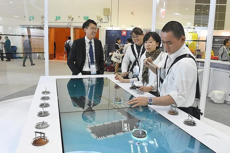 Visitors at a booth at the Sea Asia 2019 exhibition yesterday. The three-day event, with debates and discussions, aims to future-proof maritime leaders amid changes in technology as well as regulations.