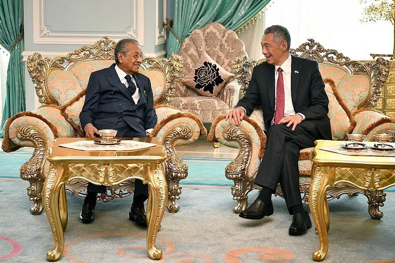 Left: Prime Minister Lee Hsien Loong with Malaysian Prime Minister Mahathir Mohamad at Seri Perdana, the latter's official residence, where the Malaysian leader and his wife hosted a lunch in honour of PM Lee and his wife yesterday. Below: Mrs Lee wi