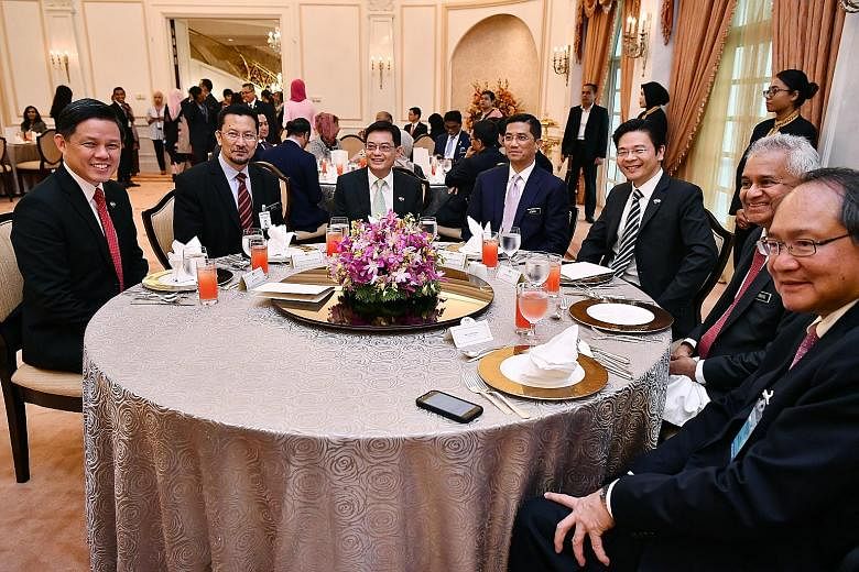 Above, from left: Singapore's Trade and Industry Minister Chan Chun Sing, Malaysia's Economic Affairs Secretary-General Saiful Anuar Lebai Hussen, Singapore's Finance Minister Heng Swee Keat, Malaysia's Economic Affairs Minister Azmin Ali, Singapore'