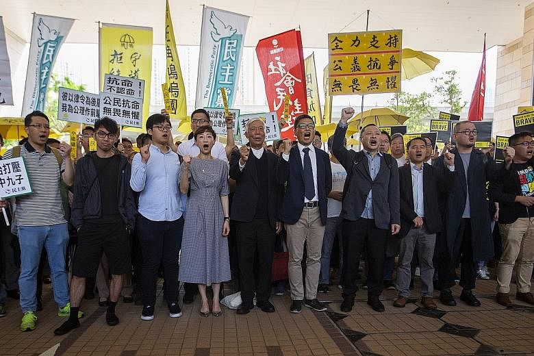 (From left) Eason Chung, Tommy Cheung, Tanya Chan, Chu Yiu Ming, Chan Kin Man, Benny Tai, Lee Wing Tat, Shiu Ka Chun and Raphael Wong in Kowloon yesterday before the court verdict. All nine were behind the massive Umbrella Movement protests centred i