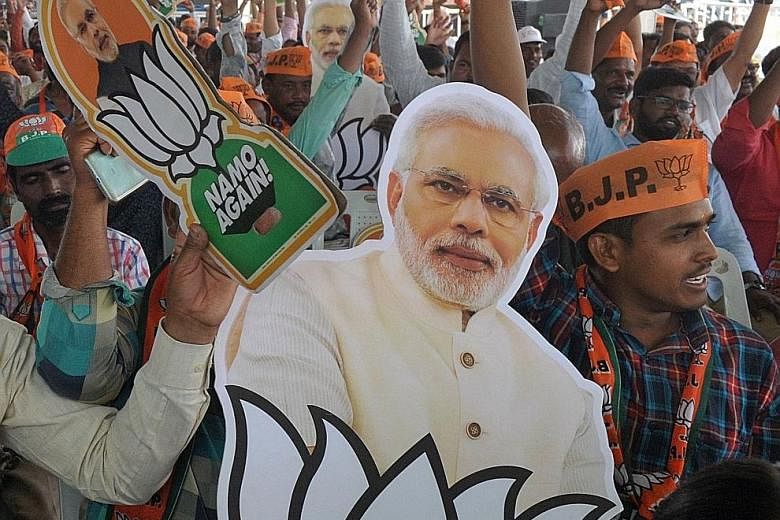 Supporters holding a picture of Indian Prime Minister Narendra Modi at a rally in Hyderabad yesterday. India is holding a general election to be held over nearly six weeks from tomorrow, when hundreds of millions of voters will cast ballots in the wo