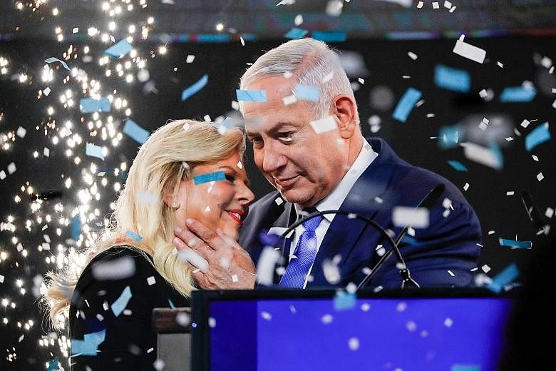 Israeli Prime Minister Benjamin Netanyahu with his wife Sara at his Likud party headquarters in Tel Aviv yesterday.