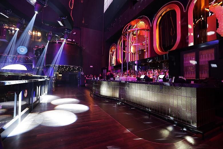 Take your partying up a notch at Marquee Singapore with rides on the Ferris wheel (above), battles on slides (right) and plenty of drink offerings at the bar (left).