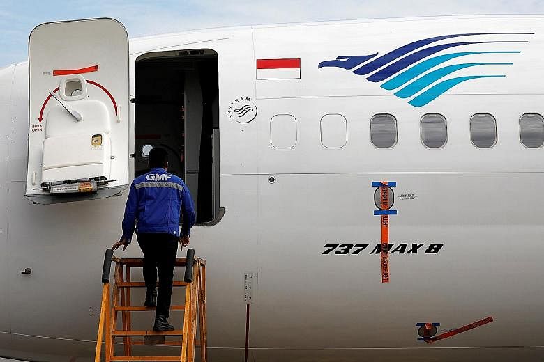 A technician prepares to check Garuda's grounded Boeing 737 Max 8 jet in Jakarta. Last month, the airline said that every month its B-737 Max 8 is laid up, it loses US$3 million.