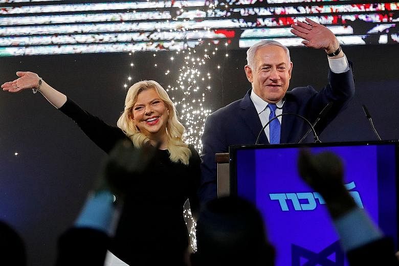The prime ministerial candidate of the Blue and White party, Mr Benny Gantz, during a rally with supporters in Tel Aviv on Tuesday. Israeli Prime Minister Benjamin Netanyahu, accompanied by his wife Sara, greeting supporters at his Likud party headqu