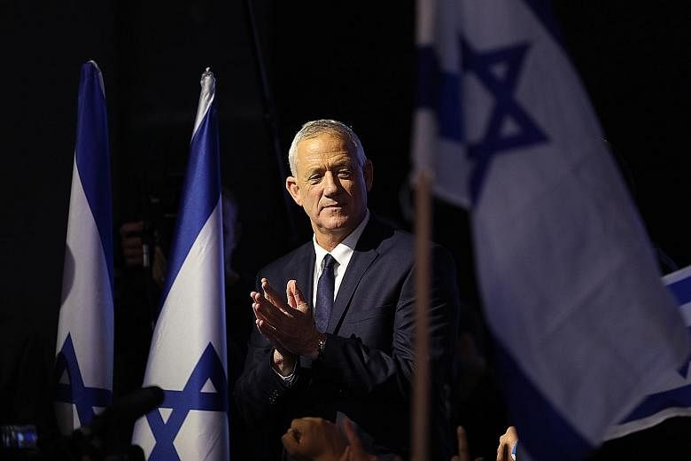 The prime ministerial candidate of the Blue and White party, Mr Benny Gantz, during a rally with supporters in Tel Aviv on Tuesday. Israeli Prime Minister Benjamin Netanyahu, accompanied by his wife Sara, greeting supporters at his Likud party headqu