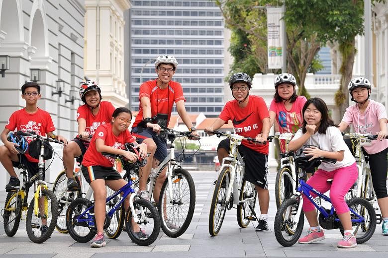 From left: Lee Boon Yee and his mother Mengchoo, sister Boon Xin and father Andy, insurance agents Patrick Teo and Sharon Ong and their daughters Kara and Joley are eagerly awaiting for next month's OCBC Cycle.