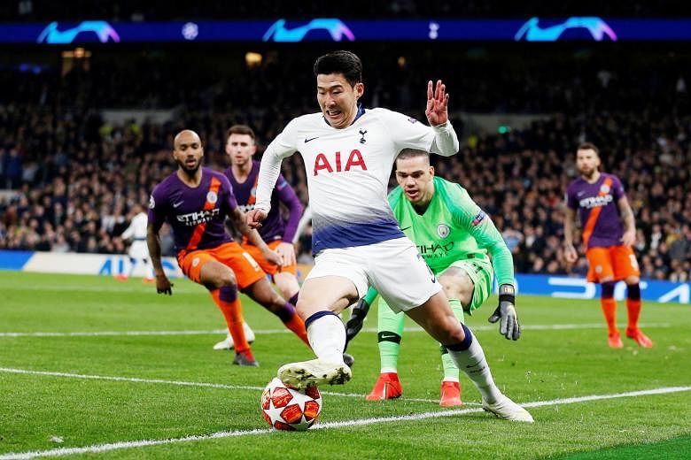 Tottenham forward Son Heung-min keeps the ball in play and beyond the reach of Manchester City goalkeeper Ederson before going on to score the game's only goal.
