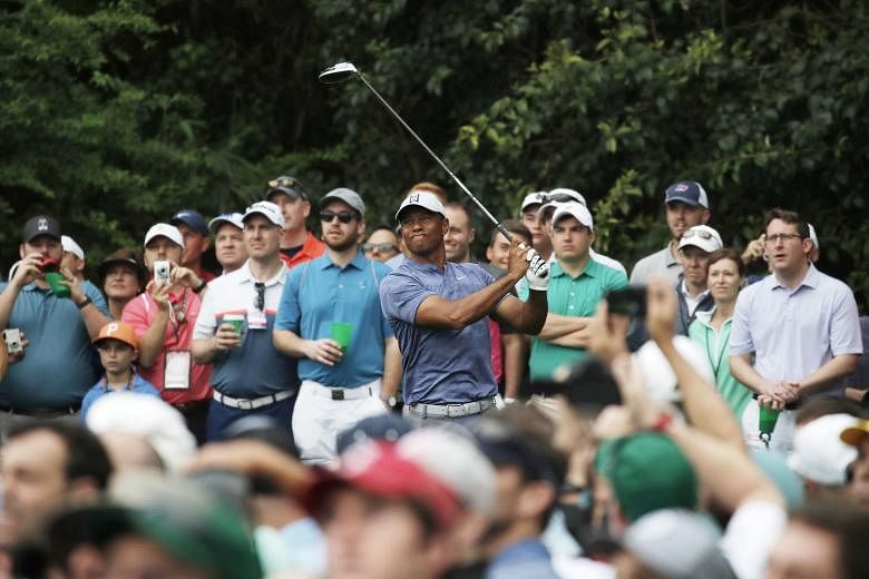 Former world No. 1 Tiger Woods hitting off the 14th tee during a practice round for the Masters tournament which starts today at Augusta National Golf Club in Georgia.
