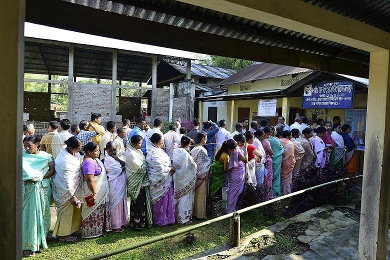 People queueing up to cast their votes at a polling station in Jorhat district of Assam, India, yesterday. Some 142 million are eligible to vote in the first phase of voting, which started yesterday, for 91 out of a total of 543 seats at stake in the