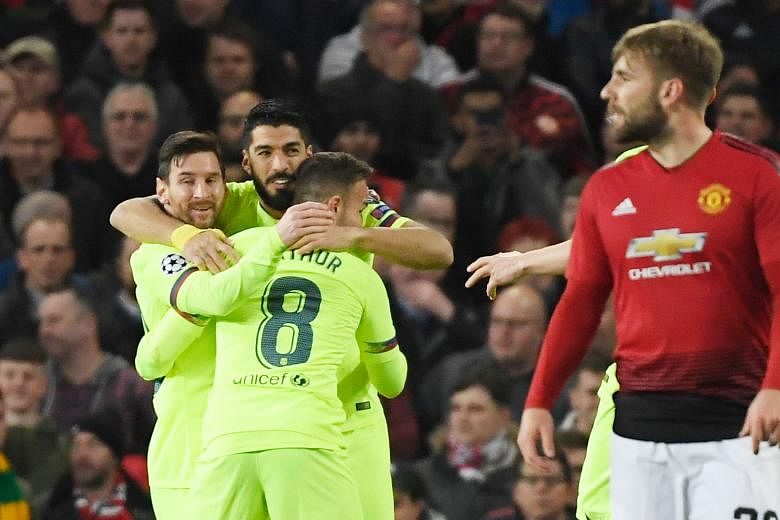Barcelona striker Luis Suarez celebrating with Lionel Messi (left) and Arthur after an own goal by Luke Shaw gave them a 1-0 first-leg win in their Champions League quarter-final tie against Manchester United at Old Trafford on Wednesday.