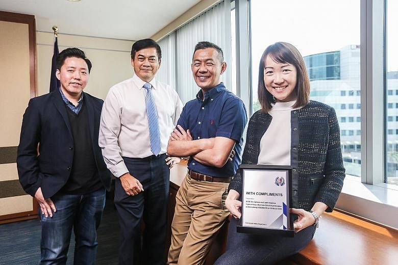OCBC Bank staff with the Public Spiritedness Award (from left): Mr Royston Soon, assistant vice-president of fraud risk management; Mr Francisco John Celio, head of corporate security; Mr Ridhwan Khoo, head of fraud risk management; and Ms Angeline W