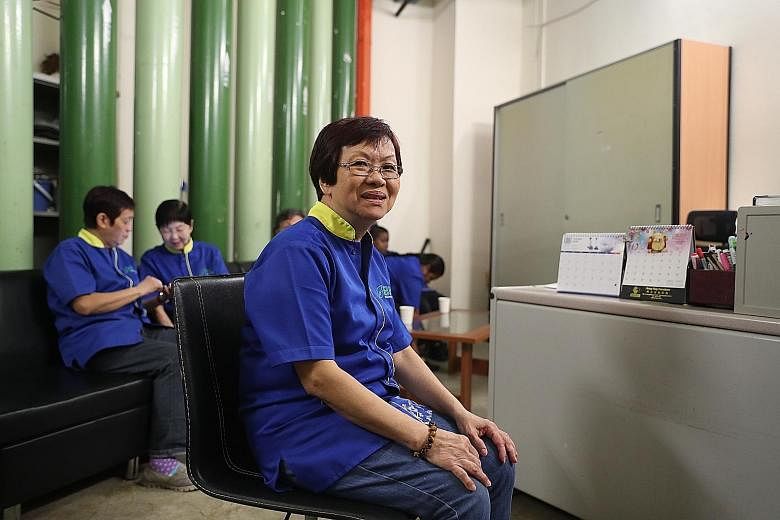 AIR-CON COMFORT Madam Lim Kwee Choo, who cleans restrooms and offices in The JTC Summit in Jurong, in an air-conditioned rest area at JTC headquarters where she can sit, relax and chat with her colleagues during her hour-long lunch breaks. The space 