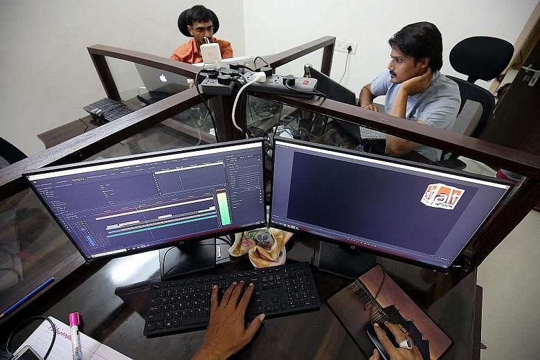 Staff of fact-checking website altnews.in in Ahmedabad checking photos and videos posted on various social media platforms. PHOTO: REUTERS