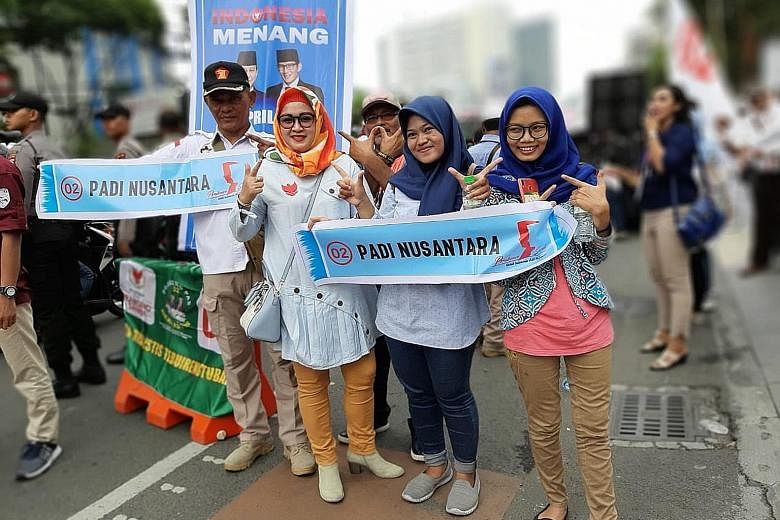 Mr Prabowo Subianto's supporters heading to a rally yesterday in Surabaya. "Padi" is an abbreviation of Mr Prabowo's name and that of his running mate, Mr Sandiaga Uno; "nusantara" means archipelago. ST PHOTO: LINDA YULISMAN