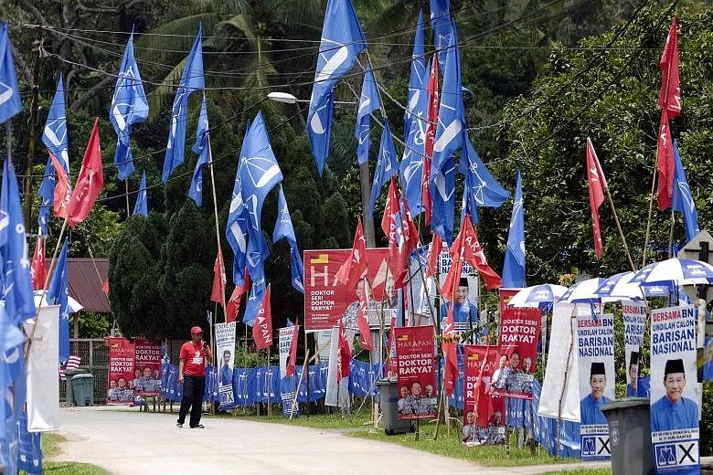 Banners of opposition coalition Barisan Nasional (BN) and of ruling alliance Pakatan Harapan (PH) in Kampung Bemban in Negeri Sembilan this week. Vying for the Rantau seat in today's by-election are BN candidate Mohamad Hasan, PH candidate Streram Si